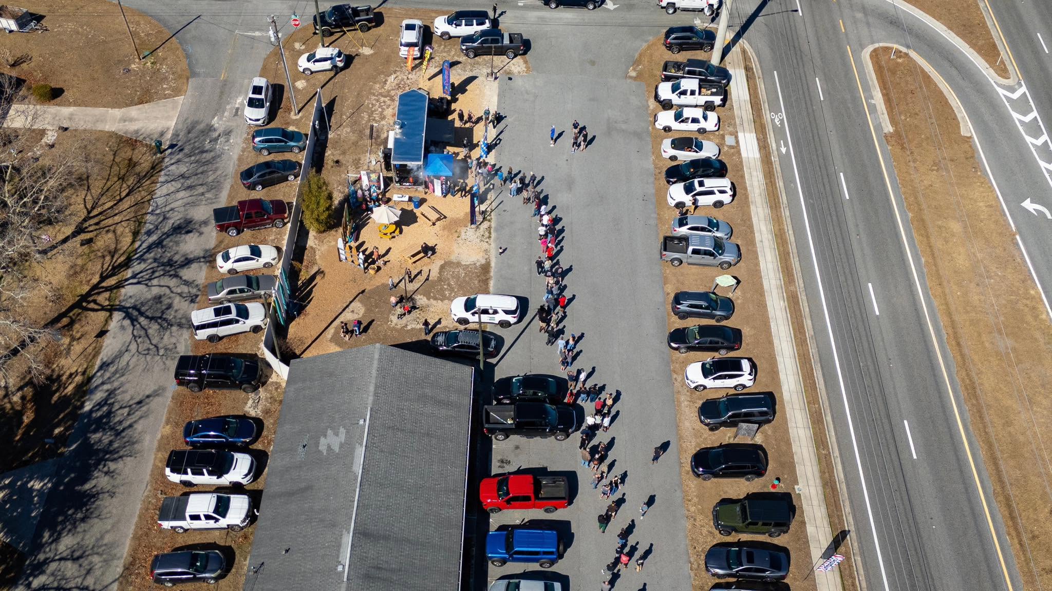 Aerial view of customers lined up at the Smokey Drew’s BBQ truck in Ocala